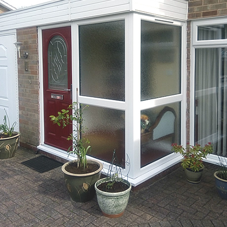 Replacement entrance porch installed with feature red composite door located in Hollywood, www.solihullwindows.co.uk