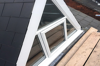 a triangular shaped window with a top hung opening by Solihull WDC, from solihullwindows.co.uk